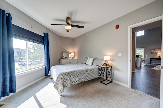 carpeted bedroom featuring visible vents, baseboards, and ceiling fan