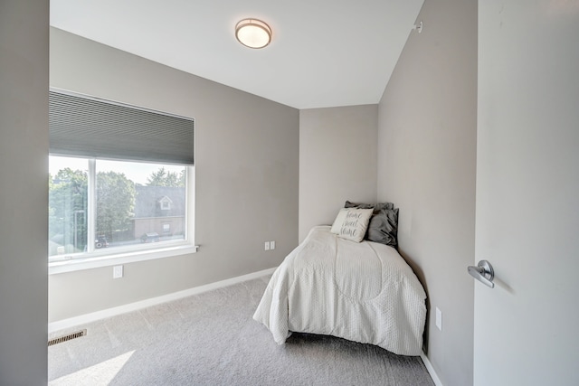 carpeted bedroom with visible vents and baseboards