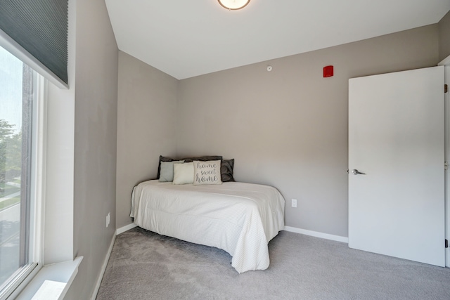 bedroom featuring carpet flooring and baseboards