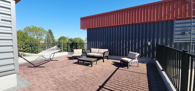 view of patio featuring an outdoor living space and a balcony