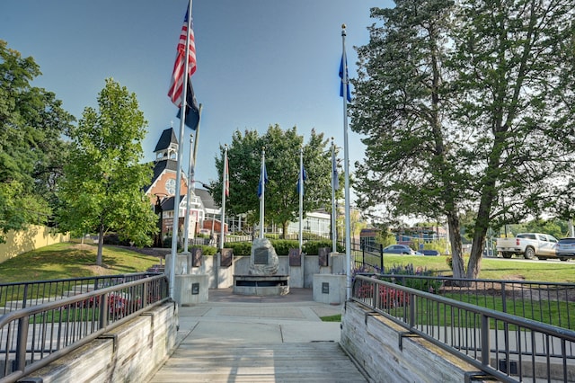 surrounding community featuring a lawn and fence