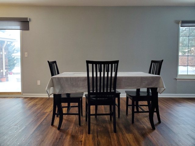 dining area with plenty of natural light and dark hardwood / wood-style flooring