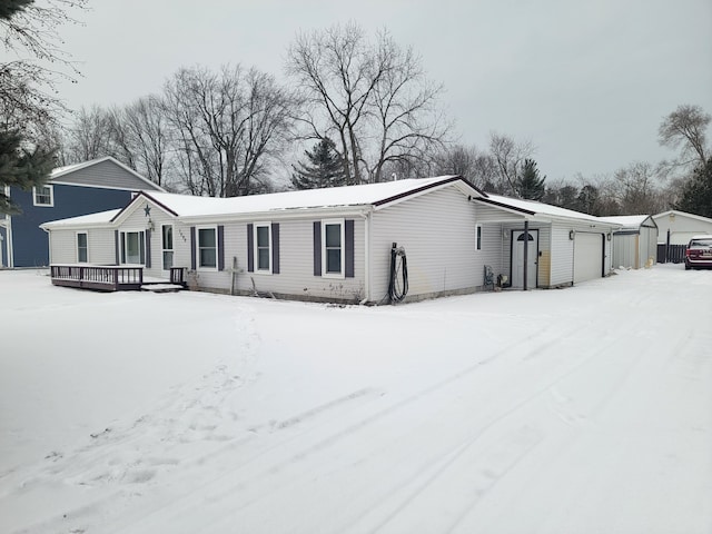 view of front of property with a garage and an outbuilding