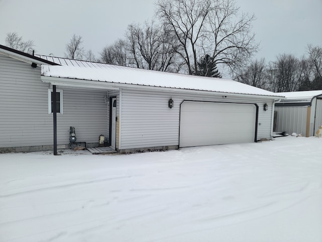 view of snow covered garage