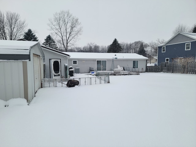 snow covered house with a porch and a garage