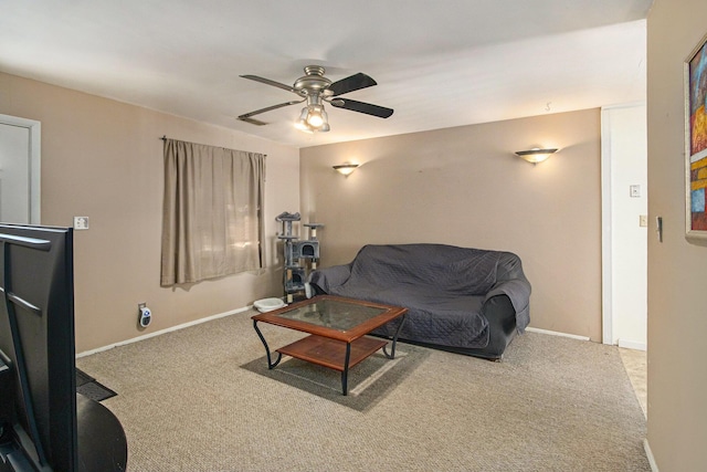 carpeted living room with ceiling fan