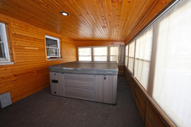 unfurnished sunroom with wood ceiling and a hot tub