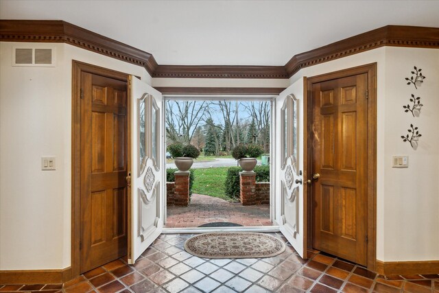 entryway featuring crown molding