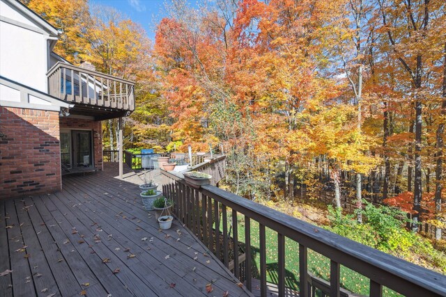 wooden terrace featuring a grill