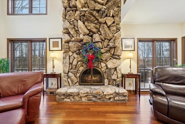 living room with dark hardwood / wood-style flooring and a fireplace