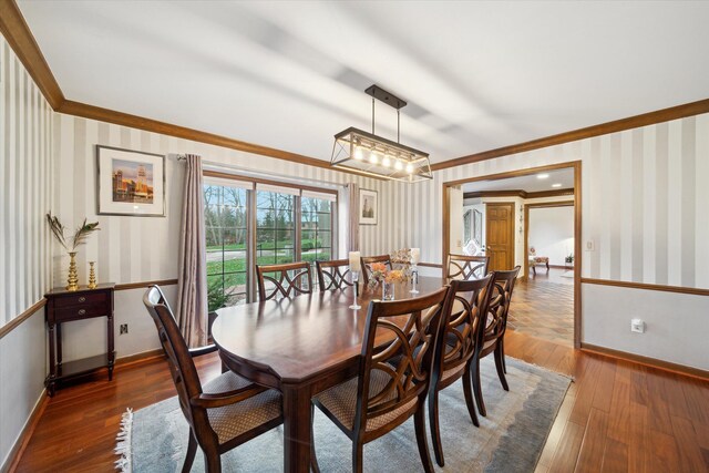 dining room featuring crown molding and dark hardwood / wood-style floors