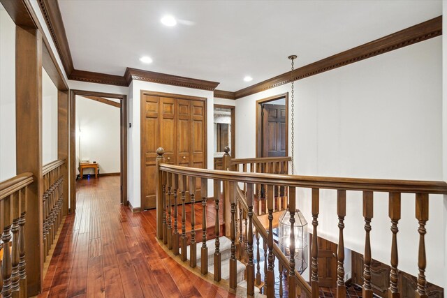 hallway featuring crown molding and dark hardwood / wood-style flooring