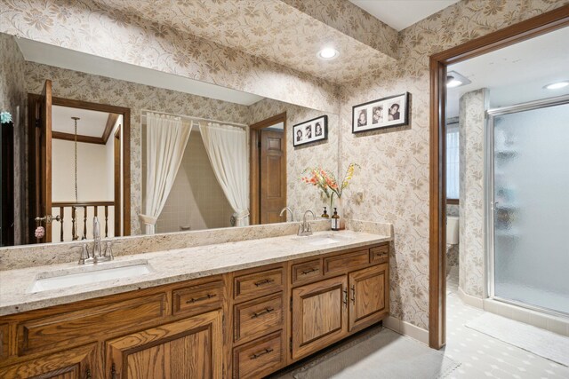 bathroom with a shower with shower door and vanity