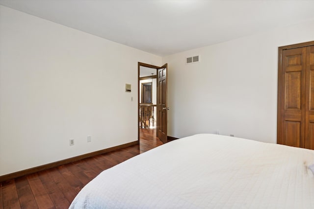 bedroom with dark wood-type flooring