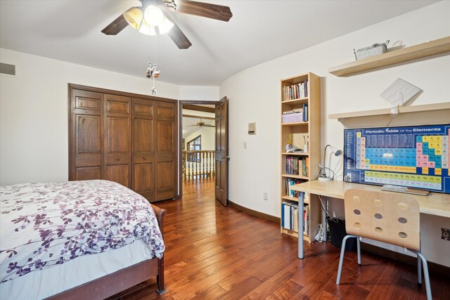 bedroom featuring dark hardwood / wood-style flooring, ceiling fan, and a closet