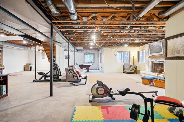 exercise room featuring a brick fireplace and billiards