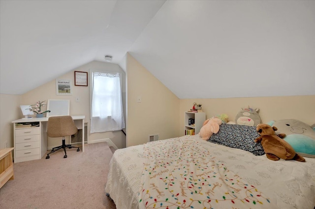 carpeted bedroom with lofted ceiling