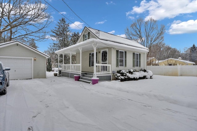 view of front facade with a porch, a garage, and an outdoor structure