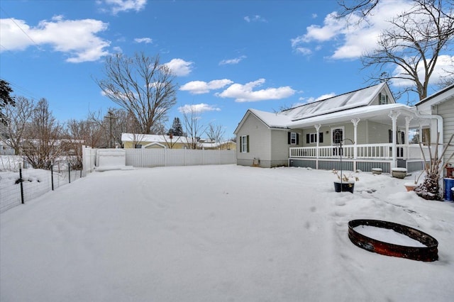 yard covered in snow with covered porch