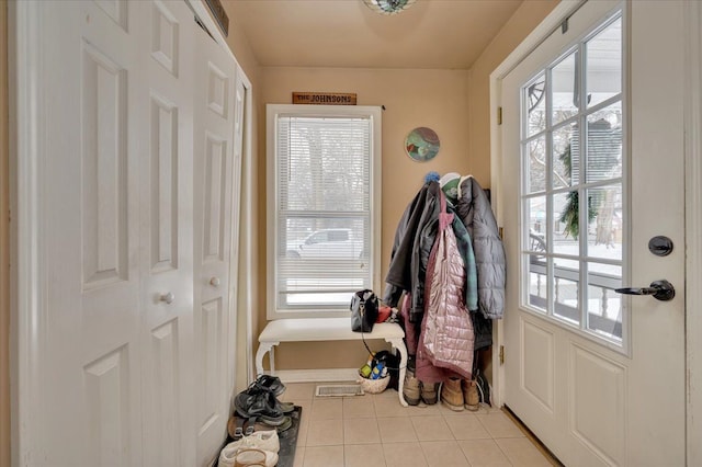 doorway featuring light tile patterned flooring and a wealth of natural light