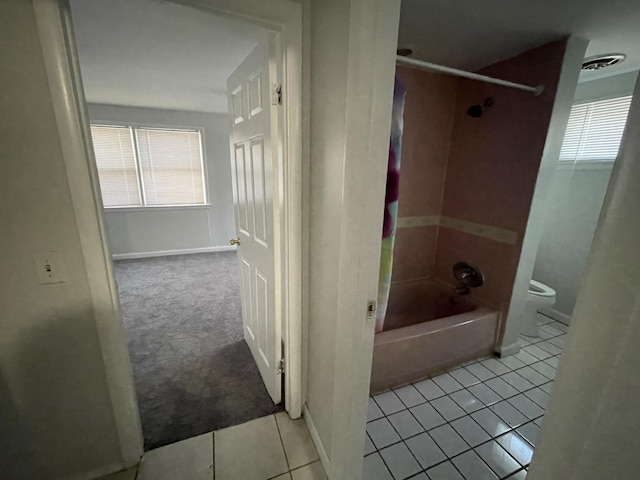 bathroom with toilet, shower / washtub combination, and tile patterned flooring