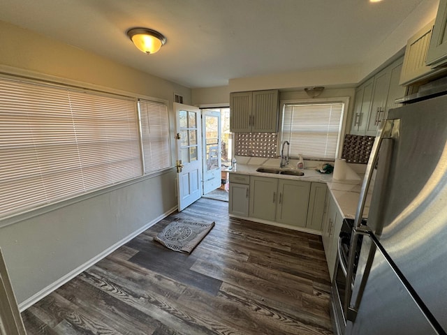 kitchen featuring stainless steel refrigerator, dark wood-type flooring, green cabinetry, and sink