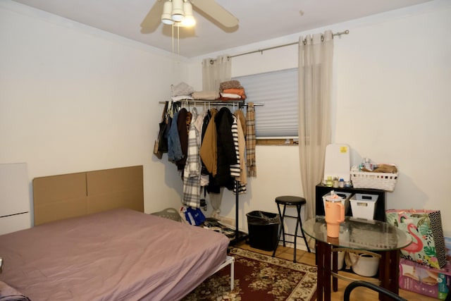 bedroom with ceiling fan and ornamental molding