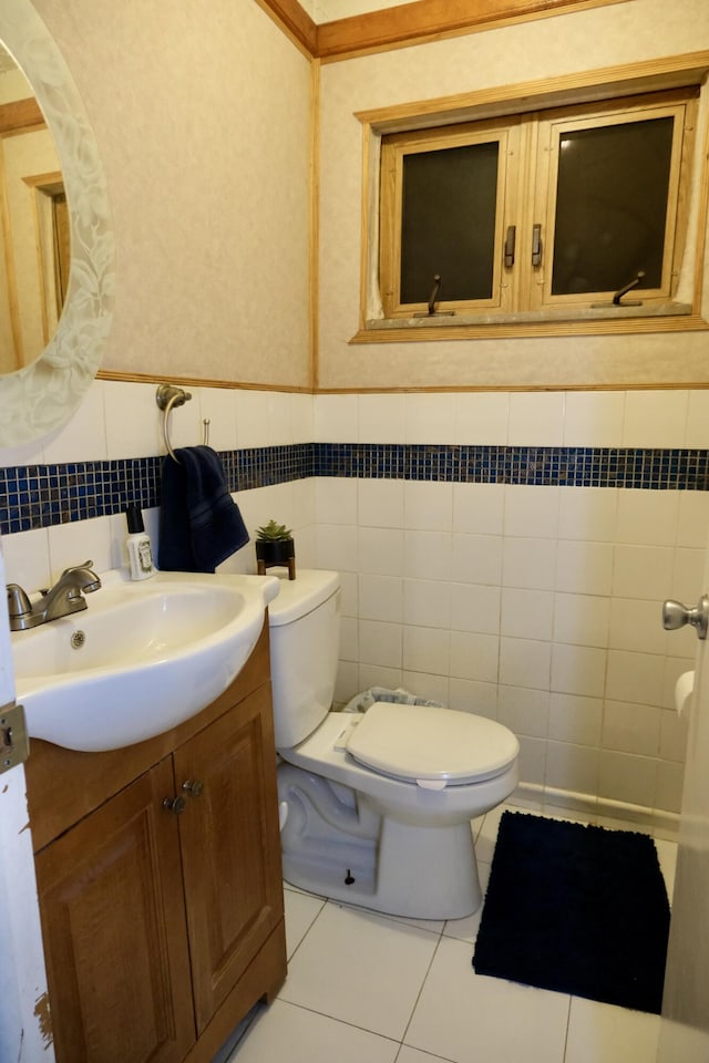 bathroom with tile walls, tile patterned floors, vanity, and toilet