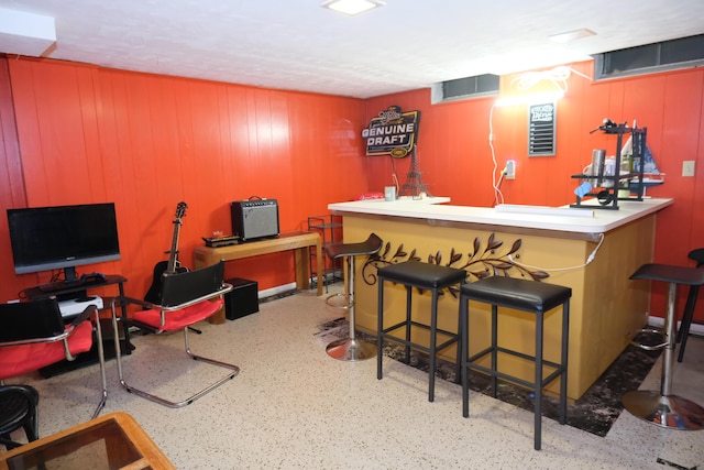 bar featuring wood walls