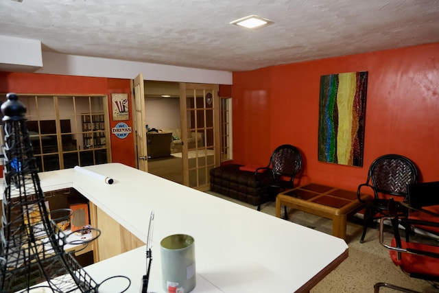 interior space featuring a textured ceiling and french doors