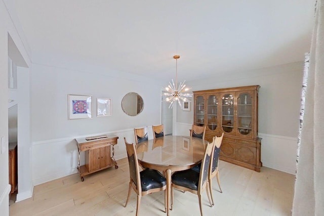 dining room with an inviting chandelier and light wood-style floors
