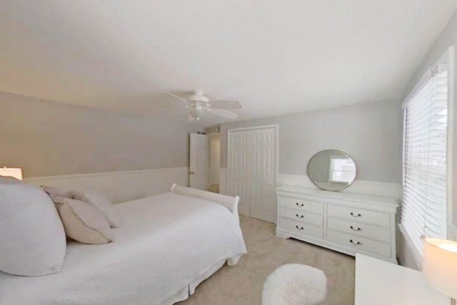 bedroom with carpet, ceiling fan, and a closet