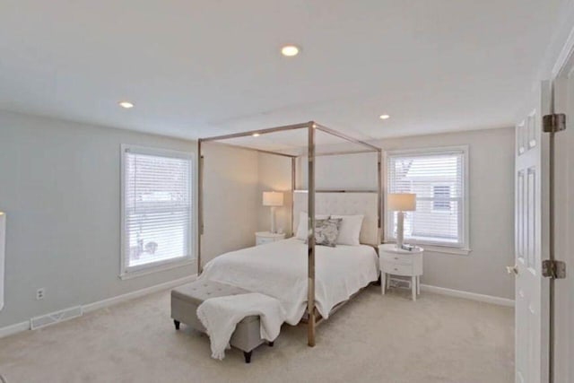 carpeted bedroom featuring baseboards, visible vents, multiple windows, and recessed lighting