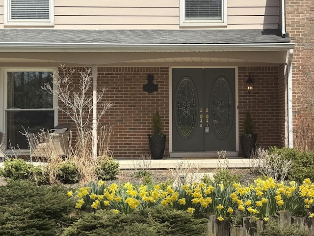 view of exterior entry featuring brick siding