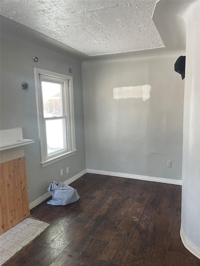 unfurnished room featuring a textured ceiling and hardwood / wood-style flooring