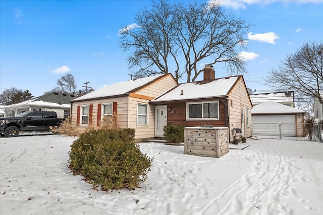 view of front of home with a garage and an outdoor structure