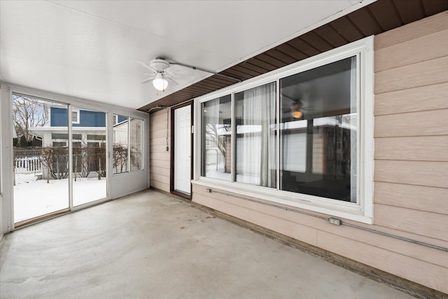 unfurnished sunroom with ceiling fan and a healthy amount of sunlight