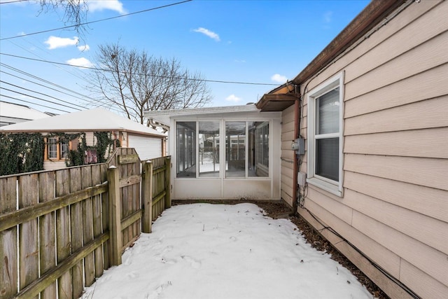 view of snow covered exterior with a garage