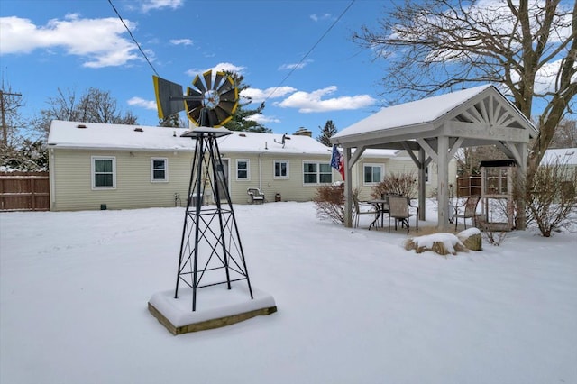 snow covered property with a gazebo