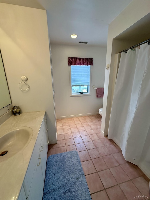 bathroom with vanity, tile patterned flooring, and toilet