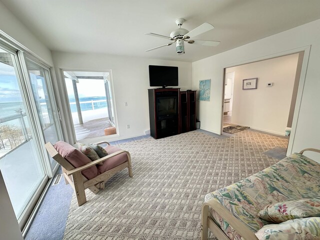 living room featuring ceiling fan and light colored carpet