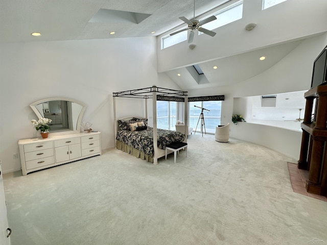 bedroom with high vaulted ceiling and light colored carpet