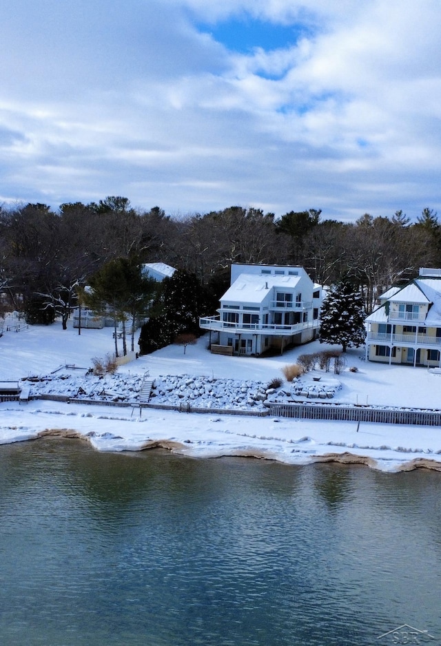 snowy aerial view featuring a water view