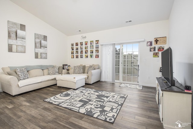 living room with vaulted ceiling and dark hardwood / wood-style floors