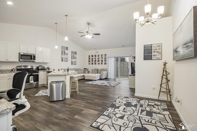 interior space with sink, dark wood-type flooring, high vaulted ceiling, and ceiling fan with notable chandelier