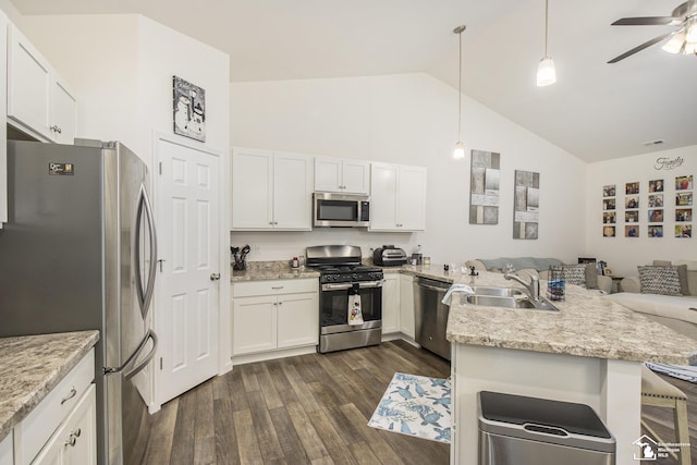 kitchen featuring stainless steel appliances, sink, decorative light fixtures, white cabinets, and kitchen peninsula