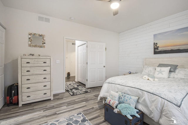 bedroom with ceiling fan and light hardwood / wood-style floors