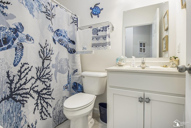 bathroom with toilet, vanity, tile patterned flooring, and a shower with curtain