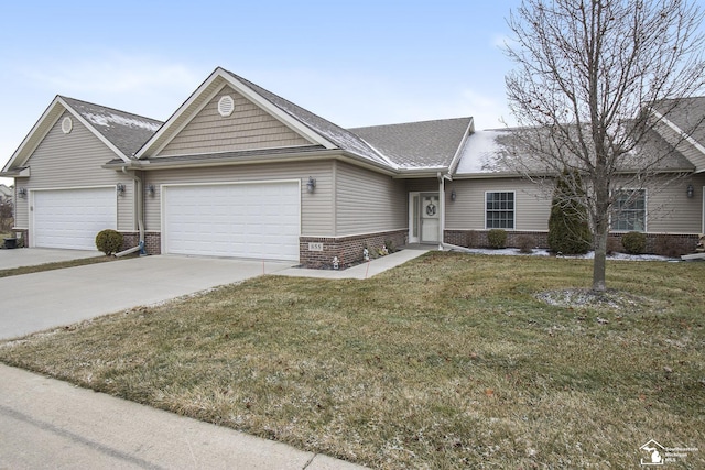 ranch-style home featuring a front lawn and a garage