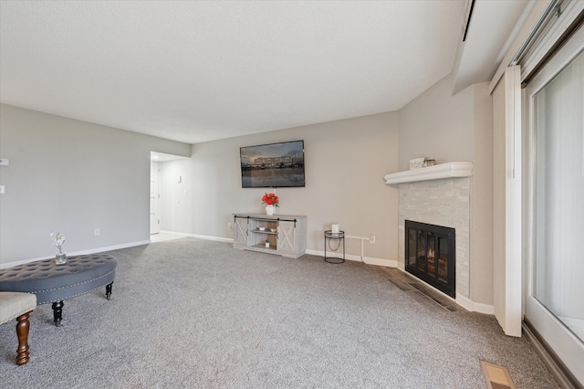 living room with carpet flooring and a fireplace